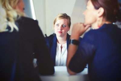 manager listening to a debate between two employees